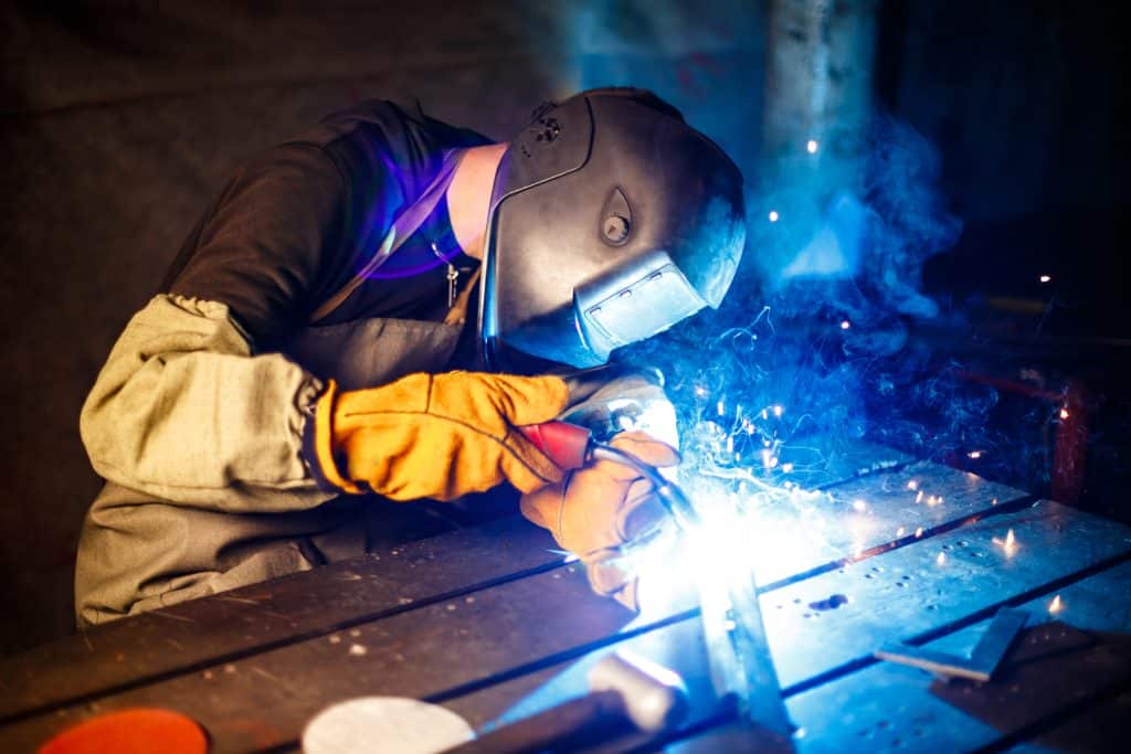 Welding steel beams for infrastructure projects, showcasing precision and strength in construction.